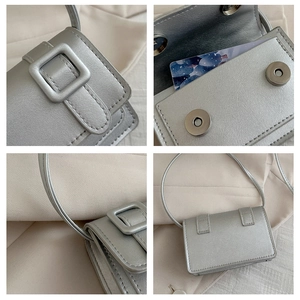 Detail of silver metallic mini bag showing the snap closure and pearl-like PU texture