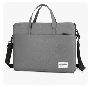 Slim grey laptop bag detail showing textured fabric and adjustable padded shoulder strap