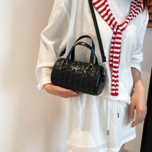 Elegant black heart-quilted Boston handbag with silver bow detail and shoulder strap