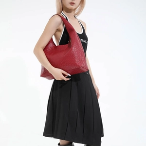 Large dark red crocodile pattern leather tote bag for women shown on a model