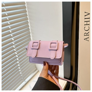 Detailed close-up of light purple micro crossbody bag featuring dual buckle flap design