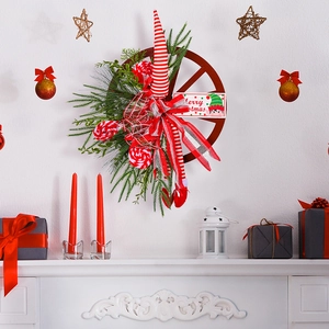 Christmas wagon wheel wreath with elf legs and Merry Christmas sign on white wall