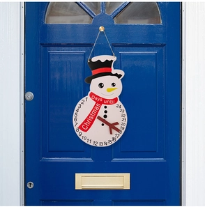 Detail of wooden snowman Christmas countdown calendar hanging on a dark blue door