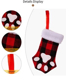 Detailed view of cat paw Christmas stocking with red plaid fabric and plush cuff