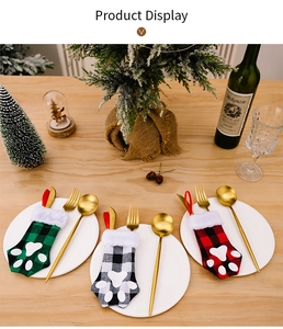 Miniature cat paw Christmas stockings used as festive cutlery holders on a dining table