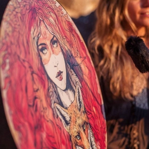 Artistic shamanic drum featuring a detailed woman and fox illustration with drumstick