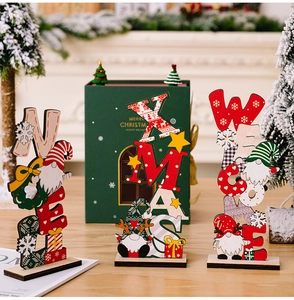 Close-up of wooden Christmas gnome signs with NOEL and XMAS prints for table decor