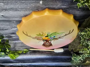 Artistic shaman drum featuring a hand-painted reindeer on a wood grain background