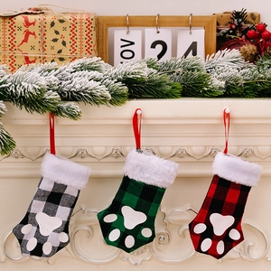 Plaid buffalo check cat paw Christmas stockings hanging on fireplace with festive decor