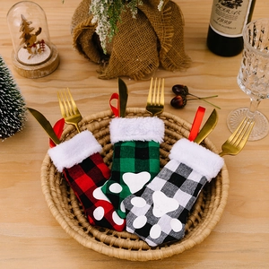 Christmas cat paw cutlery holders with gold knives and forks in holiday setting
