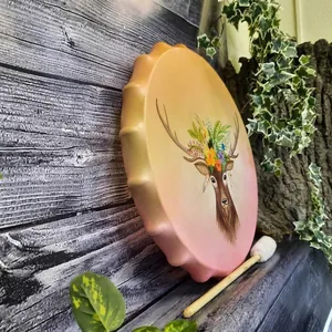 Hand-painted shaman frame drum with deer head and floral patterns including a drumstick