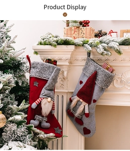 Detail of Christmas gnome stockings hanging on a white fireplace with festive decor