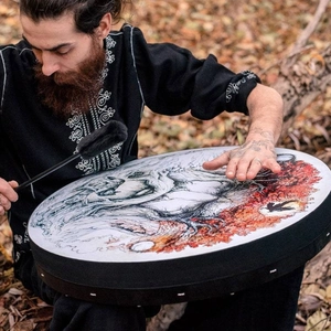 Saman drum with tree of life art and mallet on autumn forest floor, high quality view