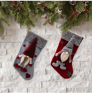 Detailed view of plush Christmas stockings with 3D gnomes, faux fur trim, and festive decor