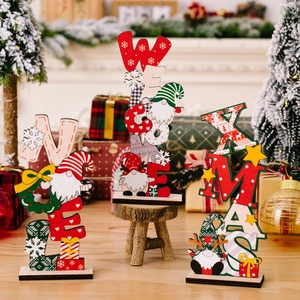 Three wooden Christmas gnome ornaments featuring NOEL, WELCOME and XMAS on a table