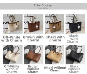 Detail view of large PU leather tote bag in four classic colors with plush charm