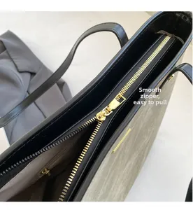 Close-up of smooth gold zipper and high-quality leather stitching on the olive tote bag