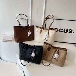 Four minimalist faux leather tote bags in brown, beige, black, and khaki with cute charms