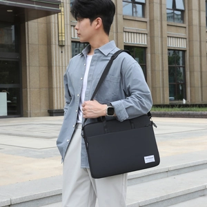 Versatile black nylon laptop bag with shoulder strap for business and school use