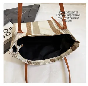 Detail of spacious interior compartment in striped canvas tote bag with black lining