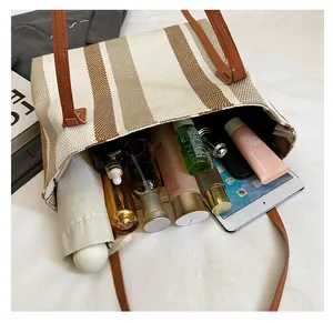 Spacious canvas tote bag showing interior storage for tablets and cosmetics