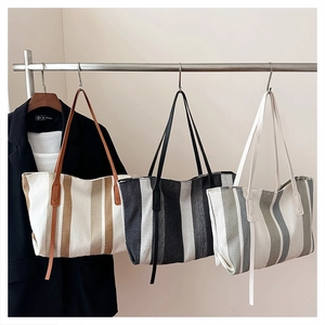 Detailed comparison of striped canvas tote bags in brown, black, and green color options