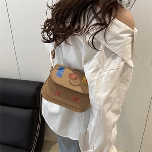 Beige saddle-shaped crossbody bag with cute patches and rabbit embroidery decoration