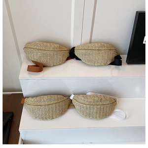 Detail of hand-woven straw belt bags with various colorful nylon straps on a white stand