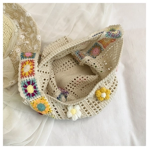 Detailed close-up of cream crochet shoulder bag with colorful 3D floral knit patterns