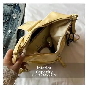 Detail showing the large interior storage capacity of the yellow PU tote bag with items