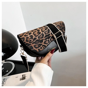 Detail of leopard print saddle bag with wide strap and gold FASHION & BAGS logo