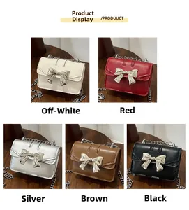 Close-up of mini flap bags with metallic bow detail in five elegant colors on wood