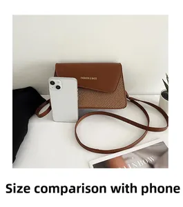 Brown leather handbag size comparison with a smartphone showing dimensions and detail