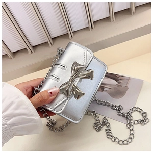 Close-up of a silver mini bag with a 3D bow and elegant metal chain strap detail