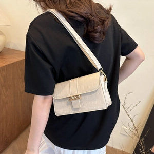 Elegant beige crocodile-patterned shoulder bag with a gold clasp for stylish women