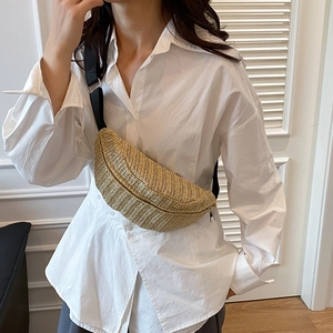 Large woven straw crossbody bag with black adjustable strap for beach travel and vacations