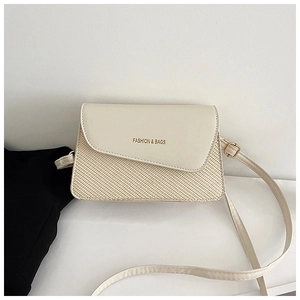 Detailed close-up of woven texture and gold lettering on cream white crossbody bag