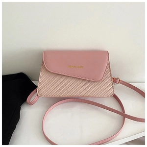 Detail of pink leather flap and textured woven base on women's crossbody bag