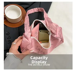 Pink silk fabric shoulder bag capacity display with bamboo leaf print and daily essentials