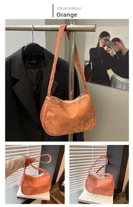 Detail of orange tote bag with vintage ink bamboo print and metal zipper closure