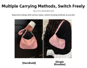 Detail of pink crescent bag showing versatile handheld and shoulder carrying styles