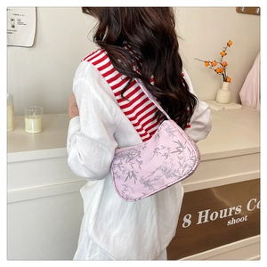 Detailed back view of pink New Chinese style underarm bag with bamboo leaf pattern and strap