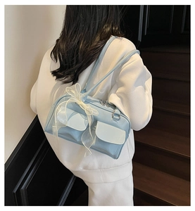 Side view of light blue soft leather shoulder bag with white lace bow decoration