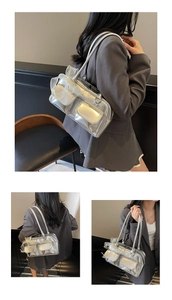 Detail of silver metallic shoulder bag with lace bow accents and utility flap pockets