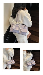 Close-up of lavender glossy leather shoulder bag with white lace bow detail and side pockets