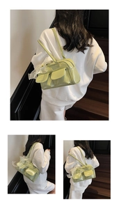 Detail view of mint green PU leather shoulder bag with pockets and mesh bow decoration