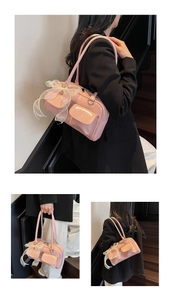 Detail of pink glossy shoulder bag featuring lace bows and functional front pockets