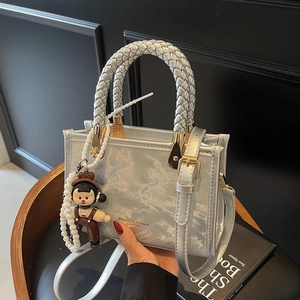 Silver metallic mini square bag with braided handle and cute charm, fashion crossbody style