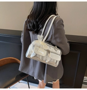 Silver metallic shoulder bag detail featuring twin front pockets and organza bow decor