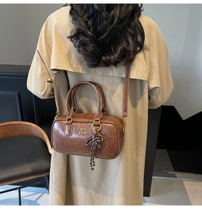 Brown vintage Boston bag shown with trench coat for practical styling and size